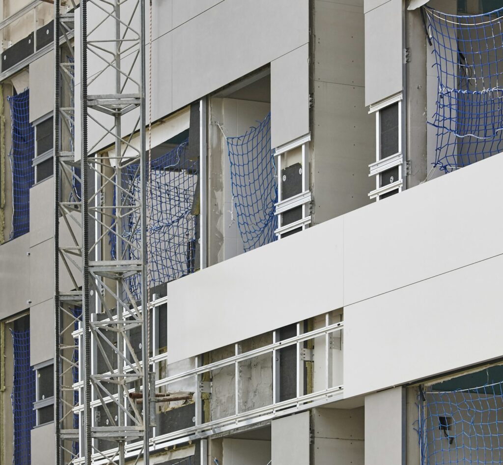 Building facade under construction. Insulation material and tiles. Horizontal